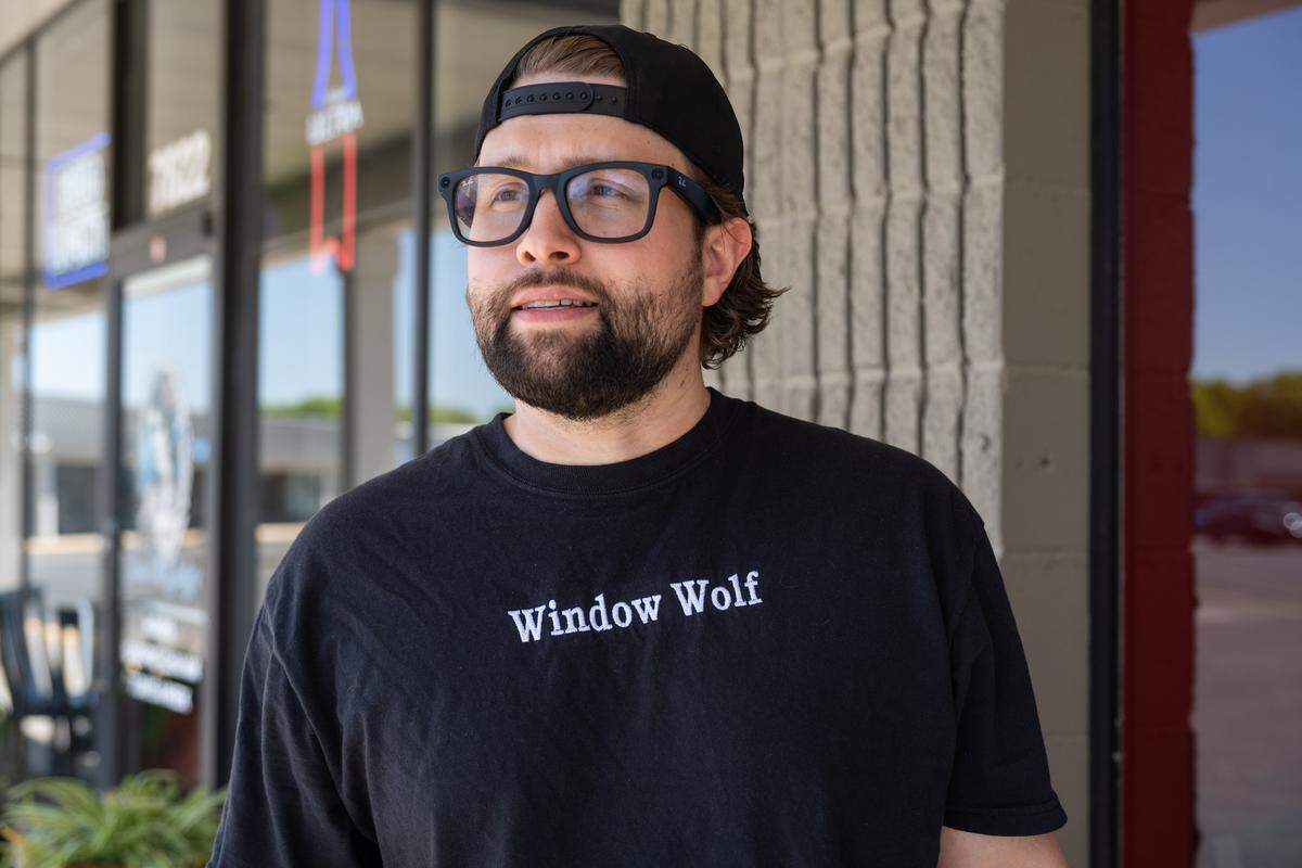 Davis Roethler outside Third Coast Pizza in Lenexa, on Monday, April 20, 2026. Roethler, who's company is named Window Wolf, uses social media to shine a light on small businesses and also cleans their windows for free.