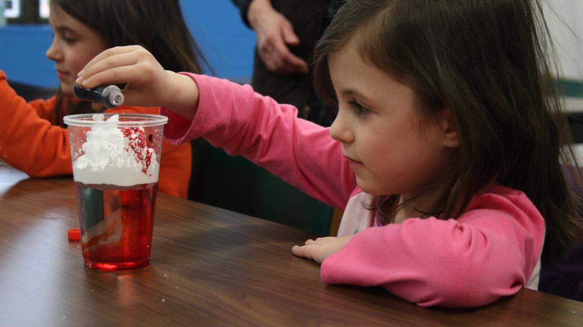 Lee’s Summit resident Caroline Rhodes, 5, adds food coloring to a cup of water and shaving cream to understand how clouds collect moisture before releasing rain. The activity was part of the program at the Lee’s Summit branch of the Mid-Continent Public Library.
