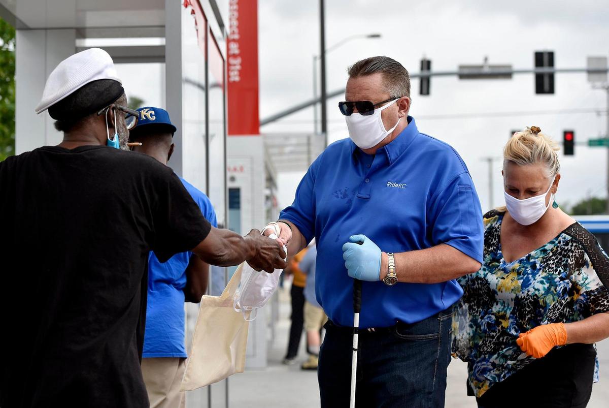 KCATA CEO Robbie Makinen gave masks away to bus riders at a stop at 31st Street and Prospect Avenue last week. The city of Kansas City was the first jurisdiction in the area to make masks mandatory to curb the spread of COVID-19.