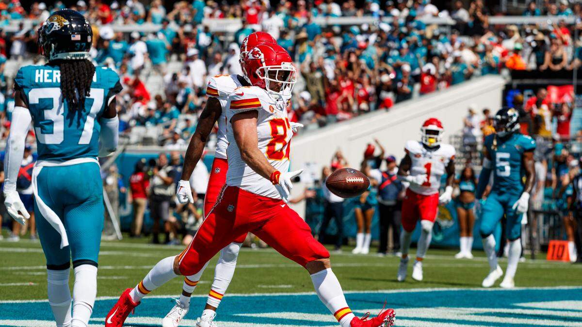 Kansas City Chiefs tight end Travis Kelce celebrated a touchdown against Jacksonville Jaguars by punting the ball into the stands during the third quarter at EverBank Stadium.