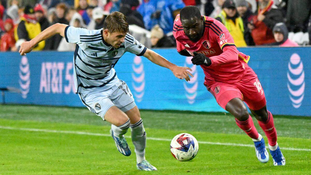 Sporting Kansas City midfielder Jake Davis, left, played tough defense against St. Louis City SC during the teams’ playoff-series opener last Sunday in St. Louis.
