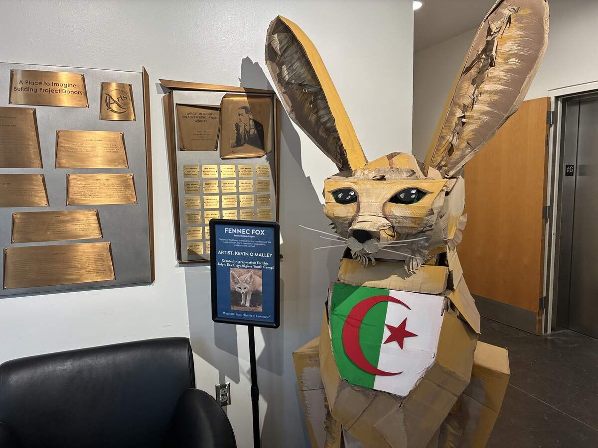 A 5-foot-tall fennec fox, the mascot of the Algerian World Cup team, stands inside the entrance of the Lawrence Arts Center.