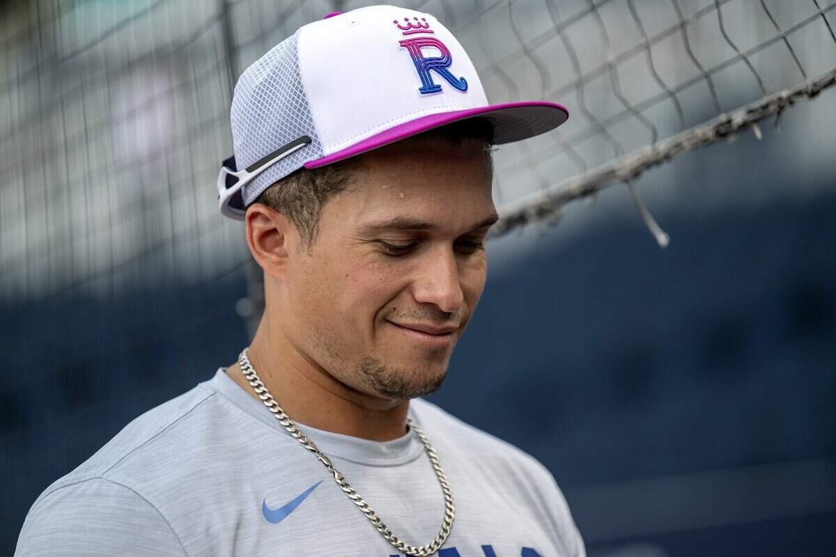 Kansas City Royals left fielder Isaac Collins (1) smiles while signing baseballs during batting practice before a game against the Houston Astros on Friday, June 12, 2026, at Kauffman Stadium in Kansas City.