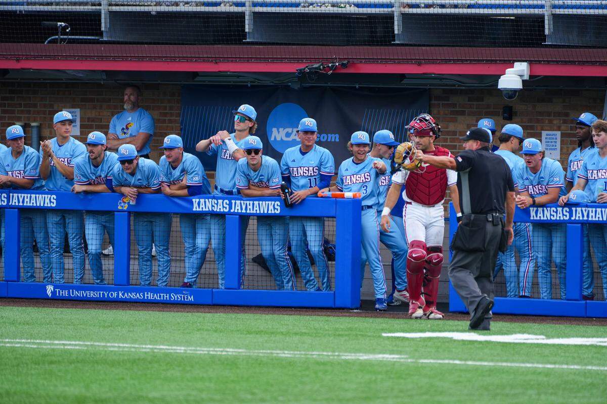 Kansas Jayhawks players watch from the dugout during the game against the Arkansas Razorbacks during NCAA baseball regionals at Hoglund Ballpark in Lawrence, Kansas, on Sunday, May 31, 2026.