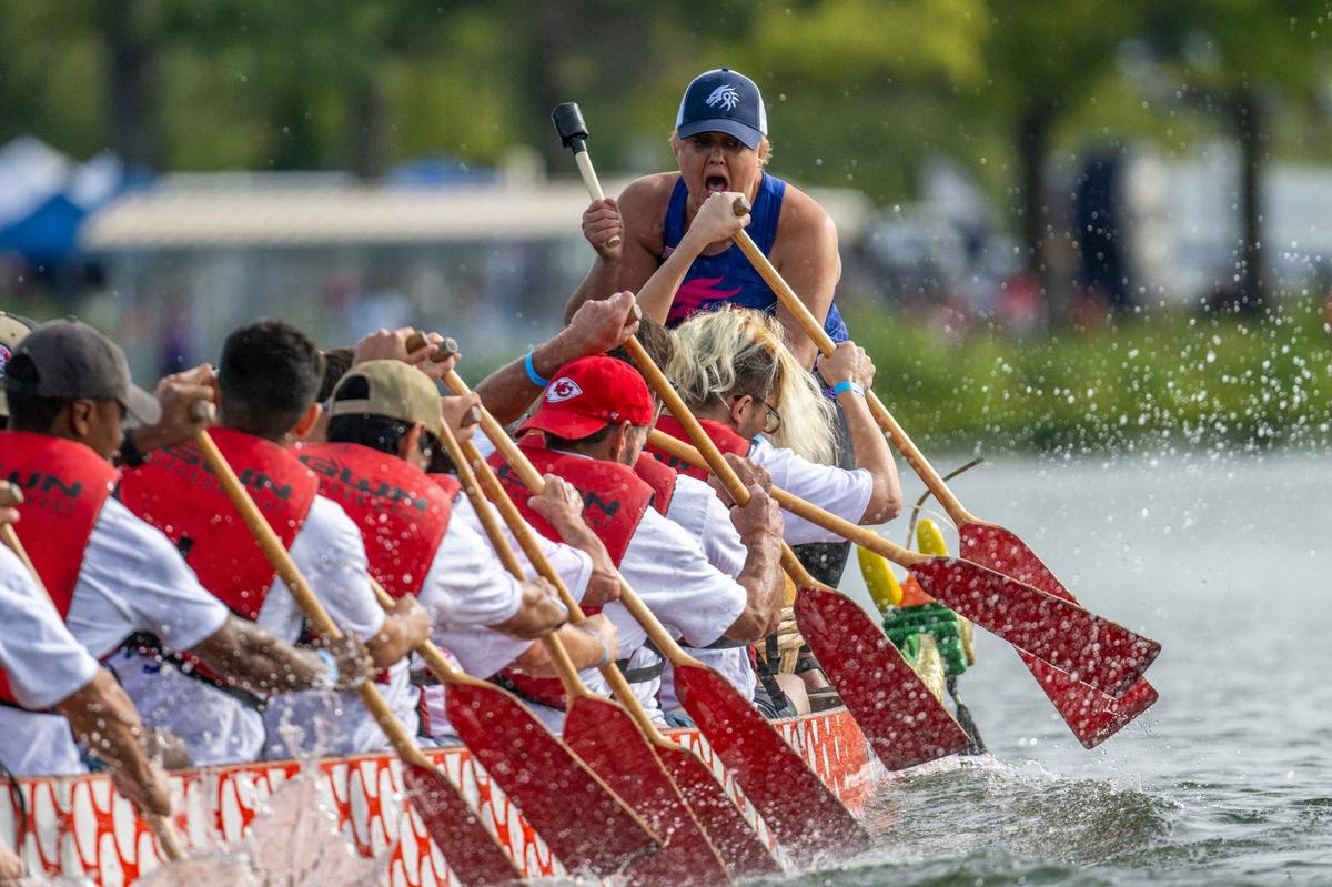A drummer from KC Pink Warriors leads a crew team in a qualifying race during the KC Dragon Boat Festival on Saturday, Sept. 28, 2024, at Shawnee Mission Park.