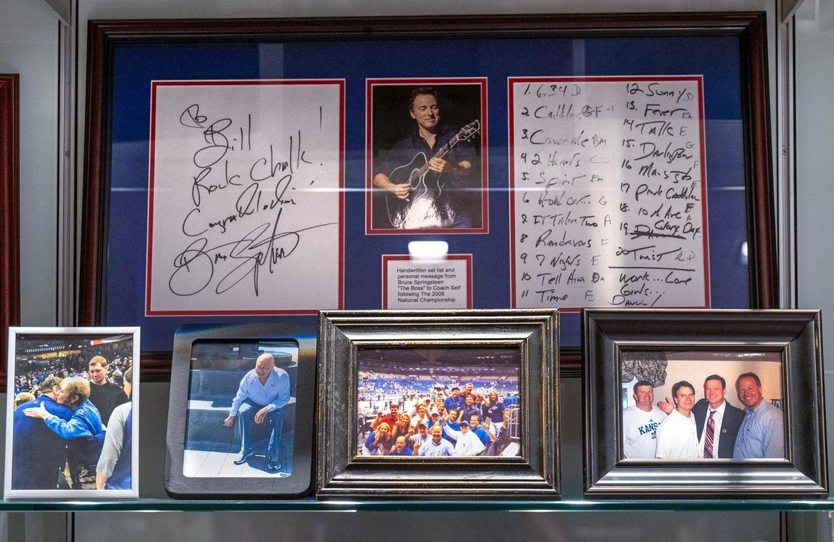 A letter and setlist from Bruce Springsteen sits on a shelf in Self’s office among photographs of family and friends, including poignant ones of Self’s mother, Margaret, hugging him after the 2022 national title and one of his father, Bill Self Sr., who died just weeks before that.