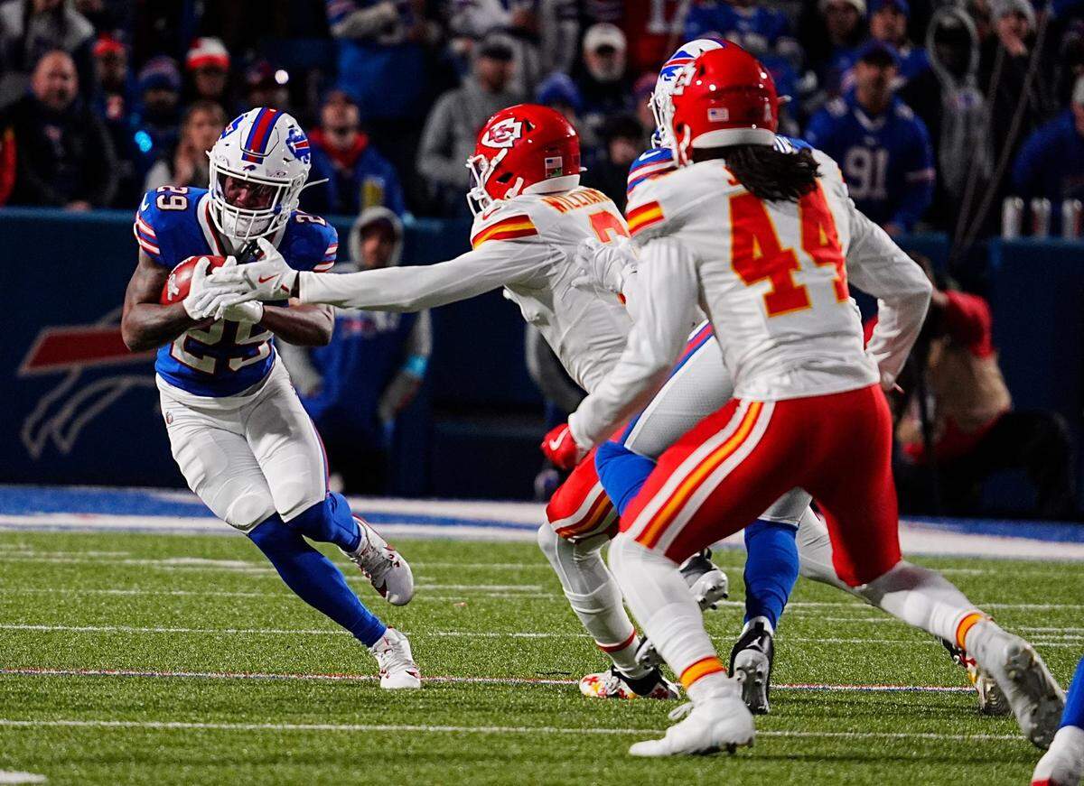 Buffalo Bills punt returner Brandon Codrington protects the ball from the outstretched arm of Kansas City Chiefs defensive back Joshua Williams during a Sunday, Nov. 17, 2024 NFL Week 11 game at Highmark Stadium in Orchard Park, New York.