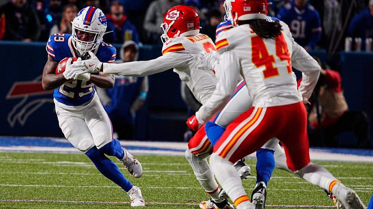 Buffalo Bills punt returner Brandon Codrington protects the ball from the outstretched arm of Kansas City Chiefs defensive back Joshua Williams during a Sunday, Nov. 17, 2024 NFL Week 11 game at Highmark Stadium in Orchard Park, New York.
