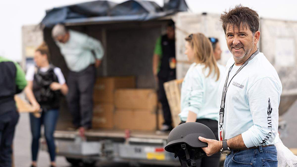 The Spirit of America team loads boxes of helmets and other protective equipment onto a plane bound for Ukraine.