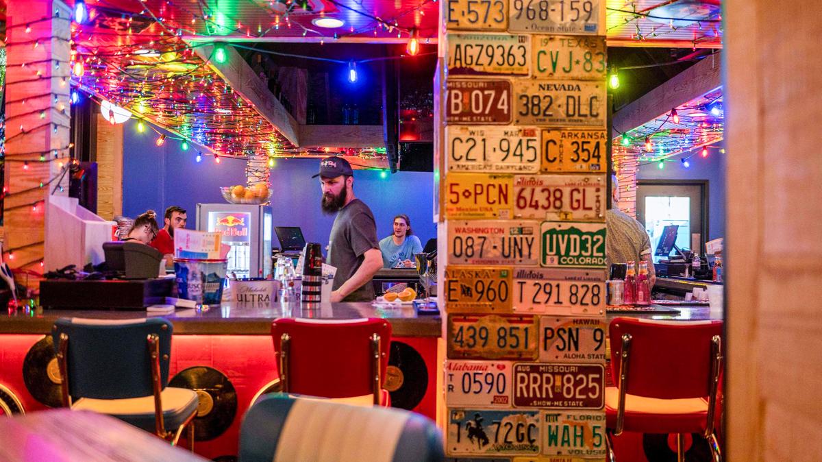 Colorful lights and license plates adorn the indoor bar area at Tin Roof in Westport.