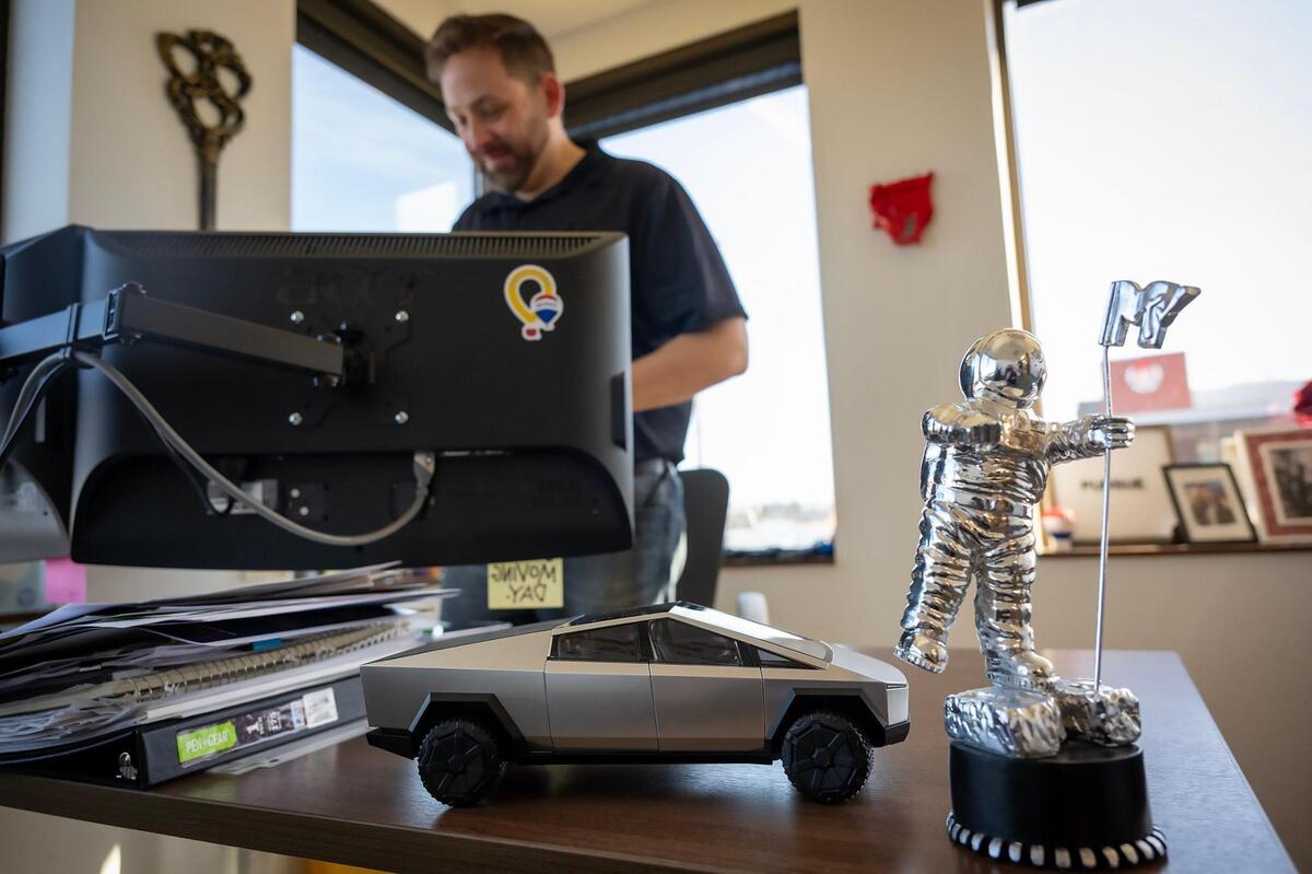 A model of a Tesla Cybertruck sits on Jay O’Brien’s desk at his RE/MAX real estate office in Liberty, Mo.