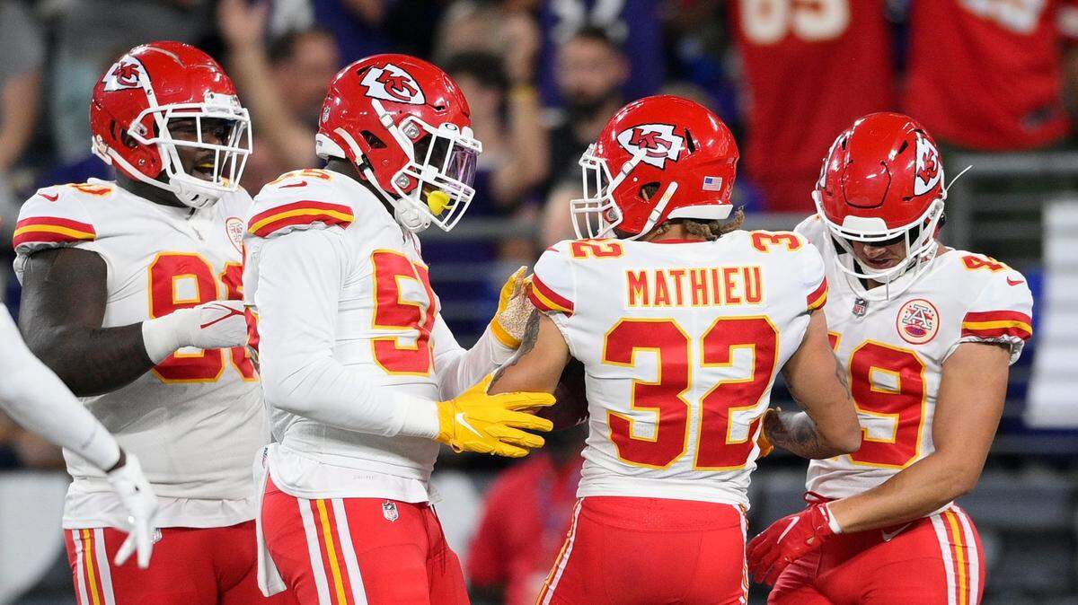 Chiefs defensive end Frank Clark, second from left, celebrates with safety Tyrann Mathieu and other teammates after Mathieu’s pick-six against the Baltimore Ravens Sunday.