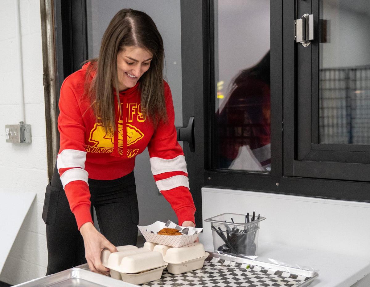 Chelsea Kever picks up her order near the commercial kitchen for LocoZilla on Thursday, Jan. 23, 2025, in Kansas City.