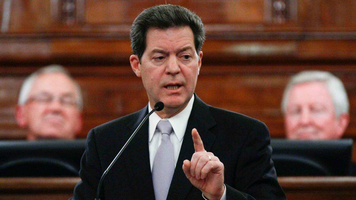 Then-Gov. Sam Brownback signed the state's first KanCare contracts in 2012.