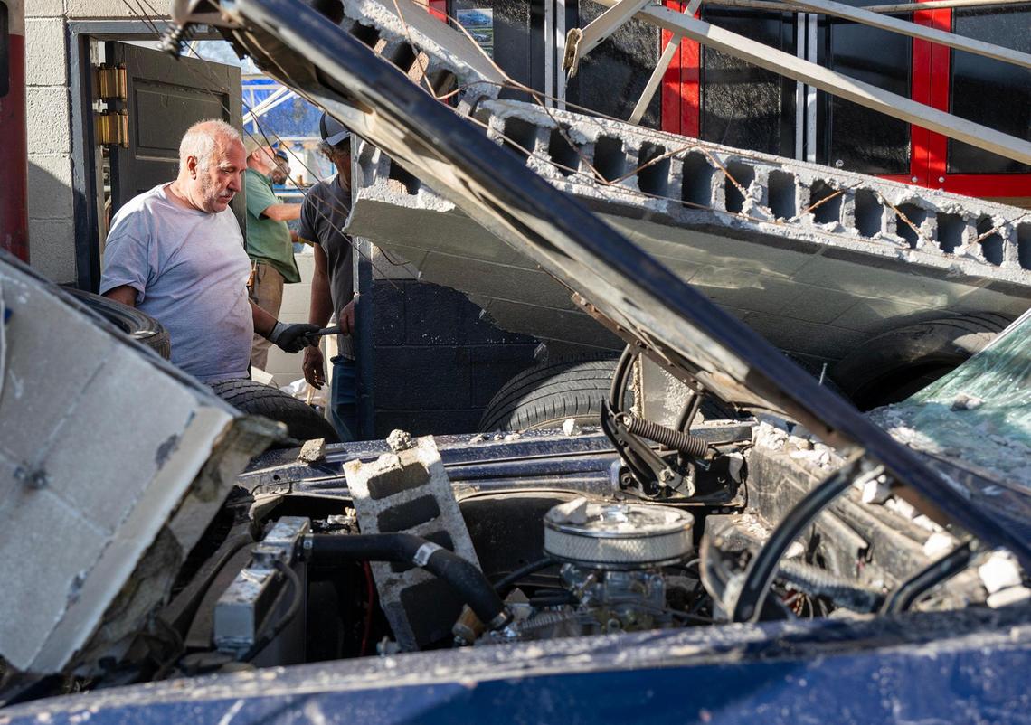 Craig Bott, center, owner of the Moundville Service Station, looks over the devastation after a tornado destroyed the station on Wednesday, April 2, 2025, in Moundville, Missouri. Bott, whose father, Lyman Bott started in the service station business in 1958, has worked at the station his entire life. This station was built in 1969.
