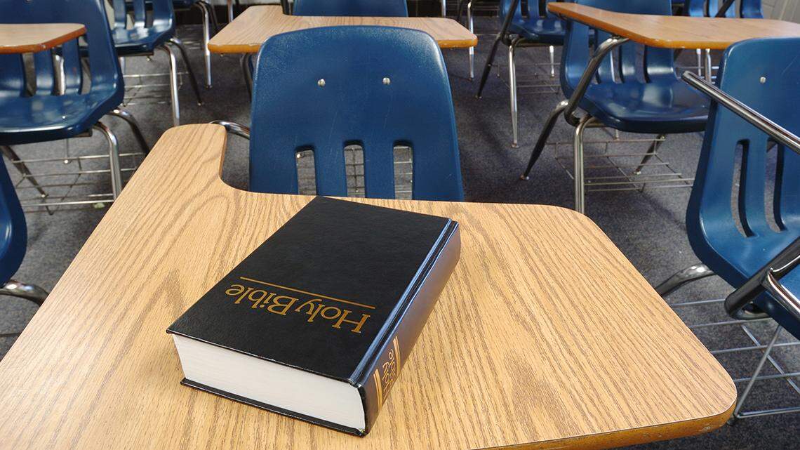 Bible on a school desk in a classroom. religion public education