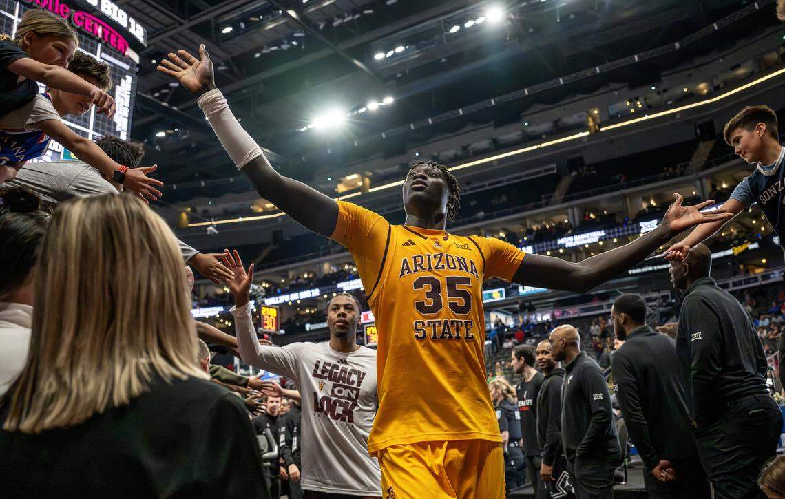 Arizona State center Massamba Diop (35) gives high-fives to fans while walking off the court after Arizona State defeated Baylor 83-79 in a Big 12 men's basketball tournament game at T-Mobile Center on Tuesday, March 10, 2026, in Kansas City.