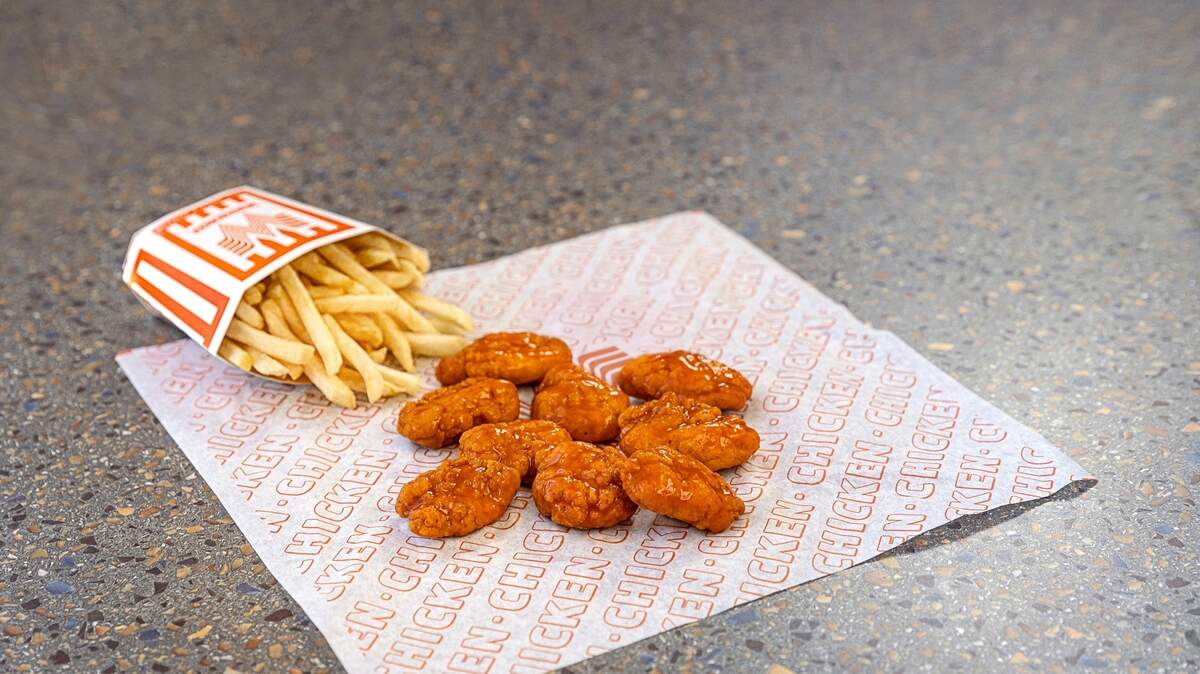 Whatawings with buffalo sauce and french fries at Whataburger.