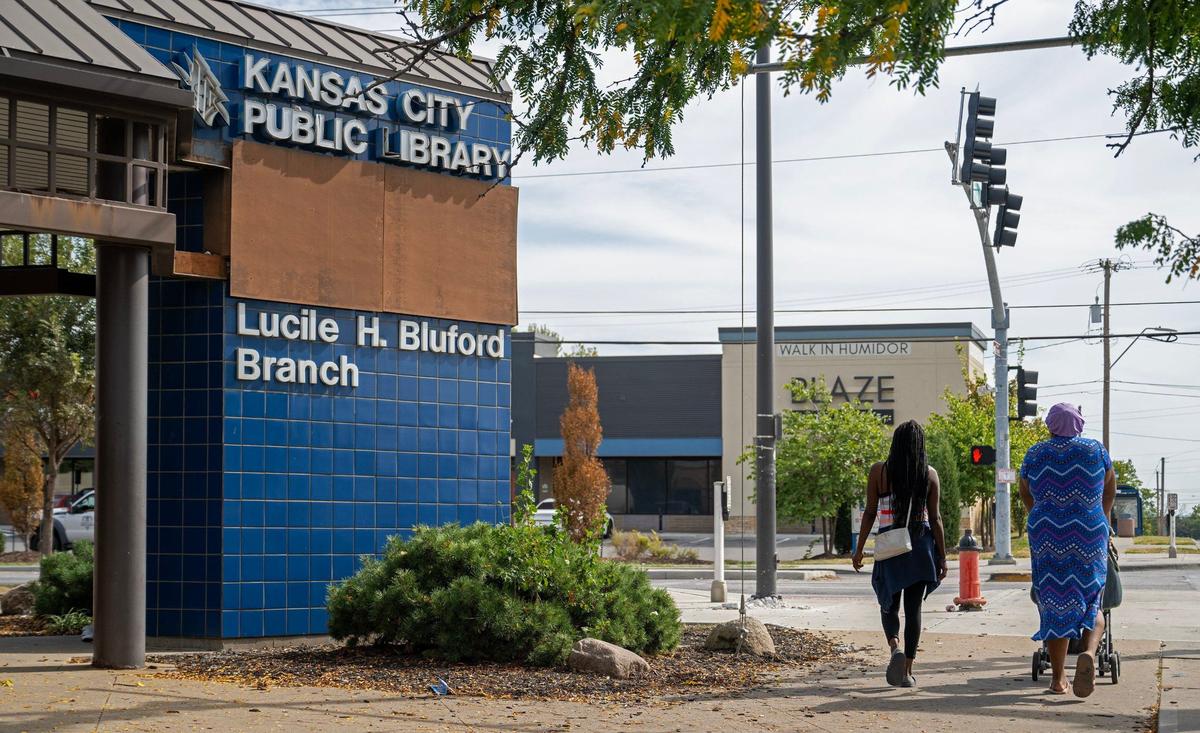 Shayron Bryers, left, Zeylona Burnett and her 10-month-old son, Kyrie, leave the Lucile H. Bluford Library on Wednesday, Sept. 18, 2024, in Kansas City. Burnett mentioned that while she feels relatively safe inside the library, her sense of security diminishes once she steps outside at East 31st Street and Prospect Avenue.