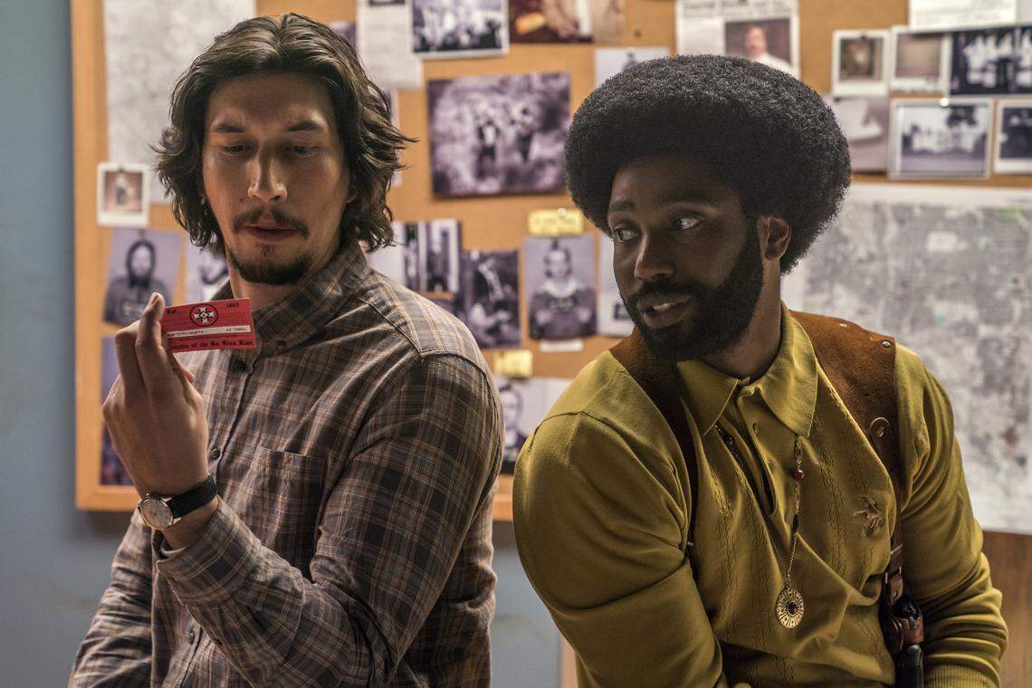 In “BlacKkKlansman,” police officer Ron Stallworth (John David Washington, right) talks his way into joining the Ku Klux Klan. His fellow officer (Adam Driver) is the one who has to meet them face to face.