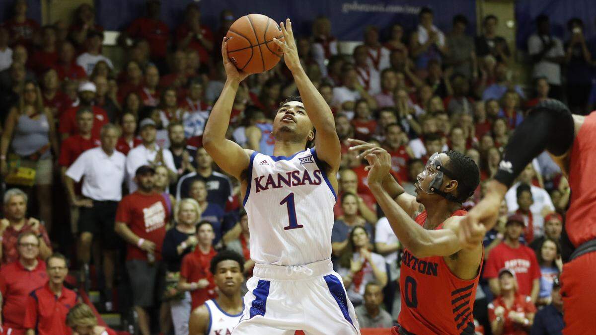 Kansas guard Devon Dotson (1) shoots over Dayton guard Rodney Chatman (0) during the first half of an NCAA college basketball game Wednesday, Nov. 27, 2019, in Lahaina, Hawaii. (AP Photo/Marco Garcia)