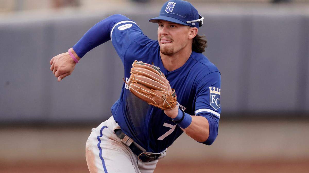Kansas City Royals third baseman Bobby Witt Jr. chases a ball during the fifth inning of a spring training baseball game against the Seattle Mariners Tuesday, March 29, 2022, in Peoria, Ariz. (AP Photo/Charlie Riedel)