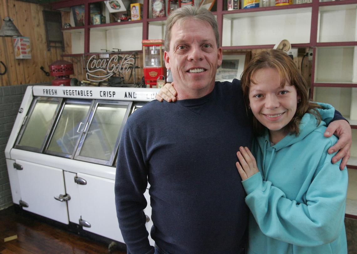 In a 2008 photo, Dennis Edwards and his daughter Erika Hochard are pictured. They talked about running the Edwards Original Corner Market together. Dennis Edwards was killed in a shooting Wednesday, his brother said. A second victim has not been identified.