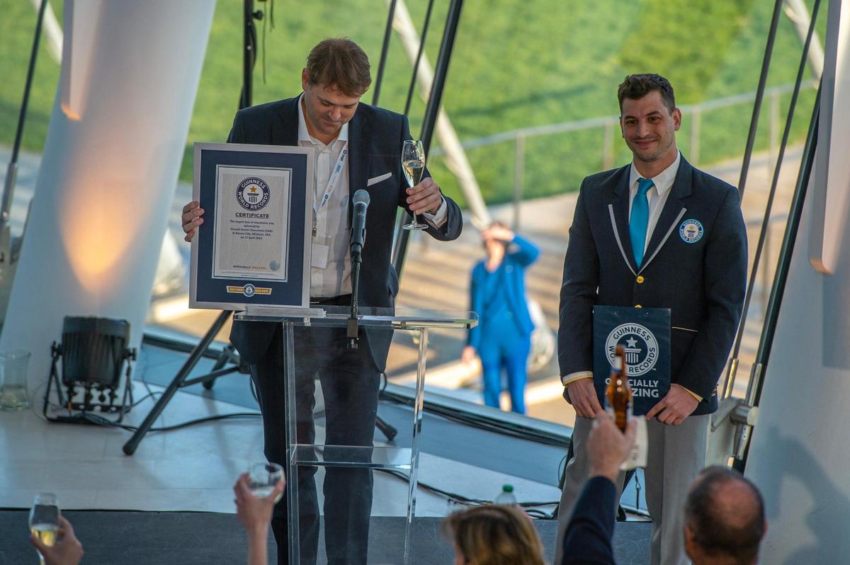 Niccolo Starace, CEO of Russell Stover Chocolates, left, accepts the Guinness World Record award for the largest box of chocolate at Kauffman Center for the Performing Arts on Monday, April 17, 2023, in Kansas City. The oversized 5,616 pound replica of the brand’s chocolate box was filled with specialty chocolates weighing from 11 to 38 pounds each.