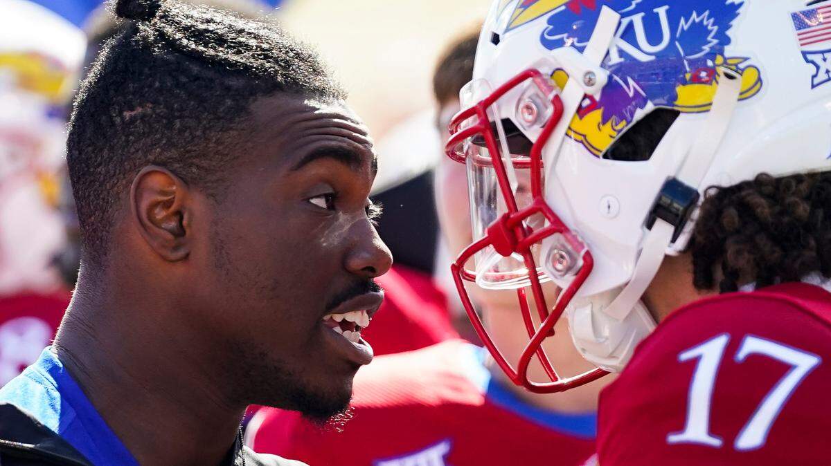 Kansas quarterback Jalon Daniels talks with Jason Bean after leaving the game against TCU due to injury at David Booth Kansas Memorial Stadium in Lawrence on Oct. 8, 2022.