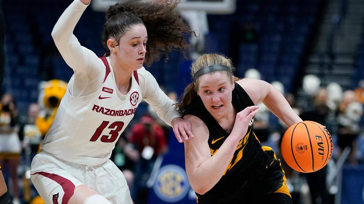 Missouri’s Hayley Frank, right, drives against Arkansas’ Sasha Goforth (13) in the first half of an NCAA college basketball game at the women’s Southeastern Conference tournament Thursday, March 3, 2022, in Nashville, Tenn. (AP Photo/Mark Humphrey)
