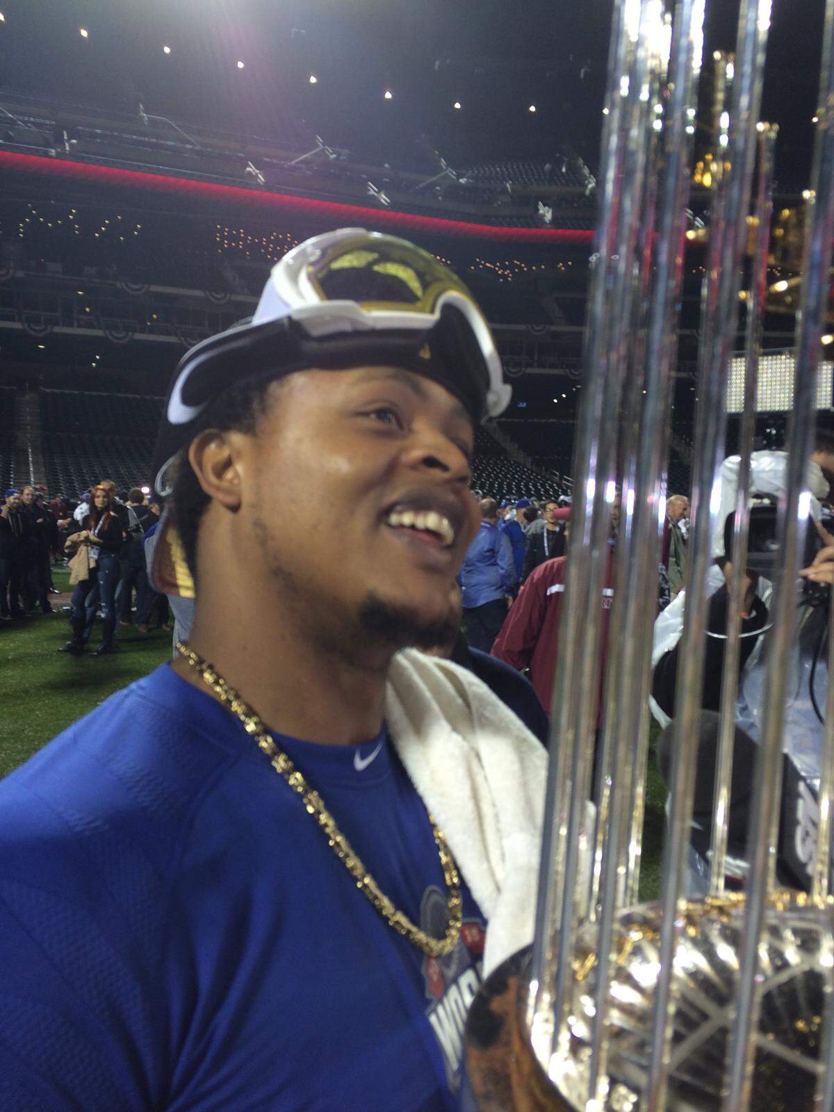 Edinson Volquez admires the most special trophy in baseball after the Royals’ World Series victory in New York.