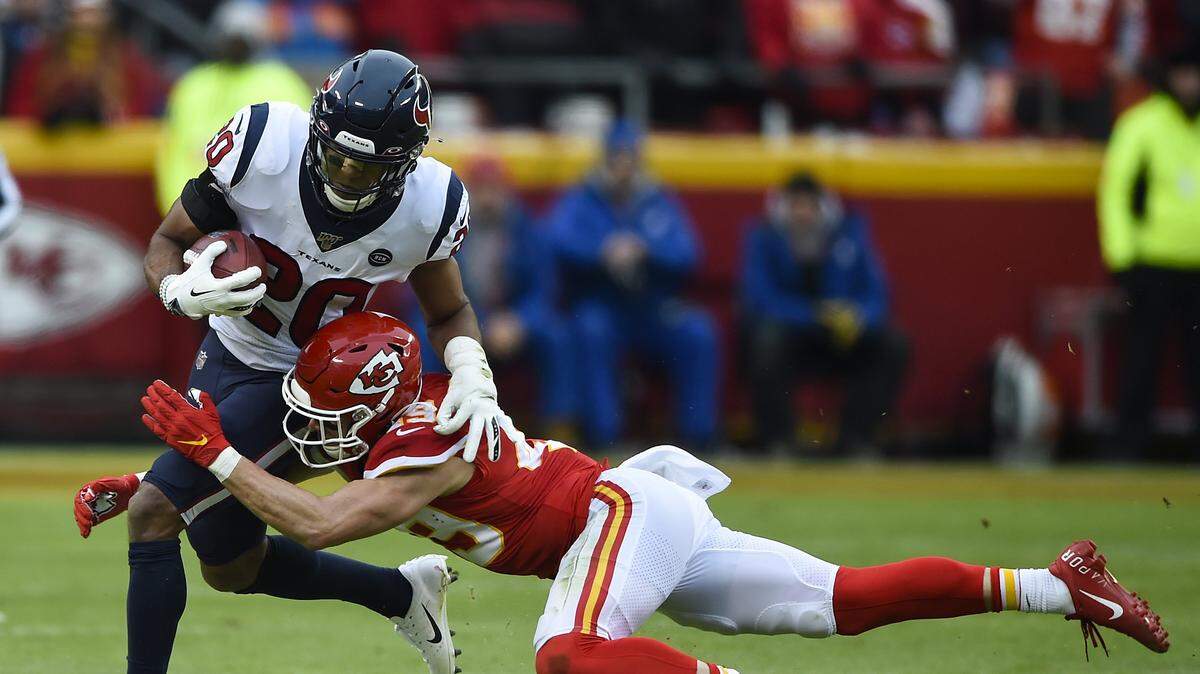 Kansas City Chiefs defensive back Daniel Sorensen wrapped up Houston Texans strong safety Justin Reid Sunday, January 12, 2020, at Arrowhead Stadium in Kansas City, Missouri.