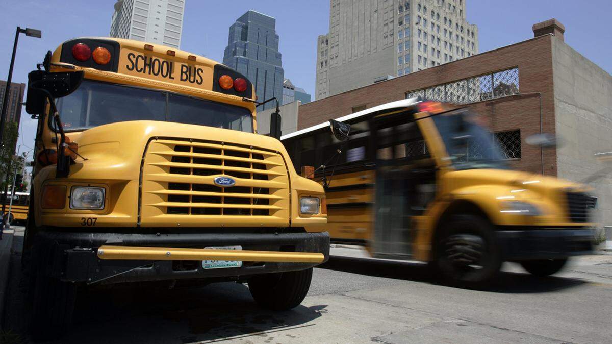 KANSAS CITY STAR/JIM BARCUS_ School buses traveling through downtown KCMO on Wednesday, June 25th, 2008. photo by JIM BARCUS
