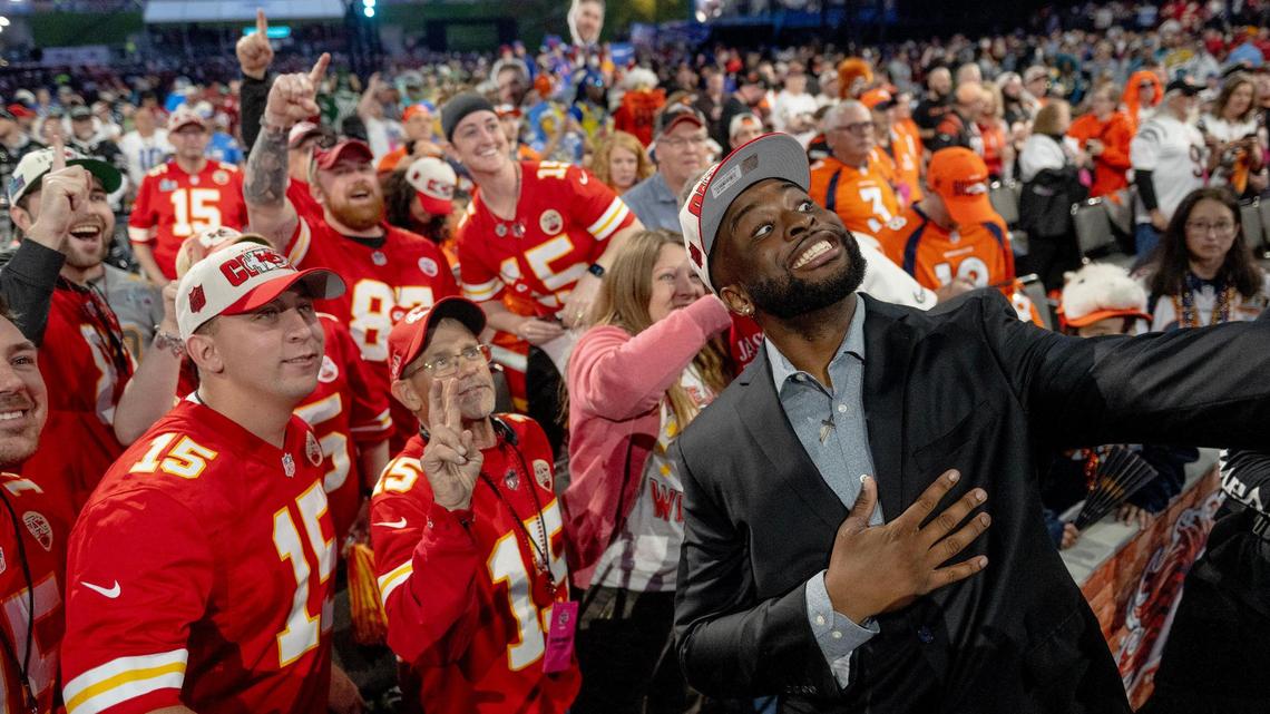 Former Kansas State defensive end and (as of Thursday’s Round 1) current Kansas City Chief Felix Anudike-Uzomah takes pictures with Chiefs fans during Friday’s second round of the NFL Draft outside of Union Station.
