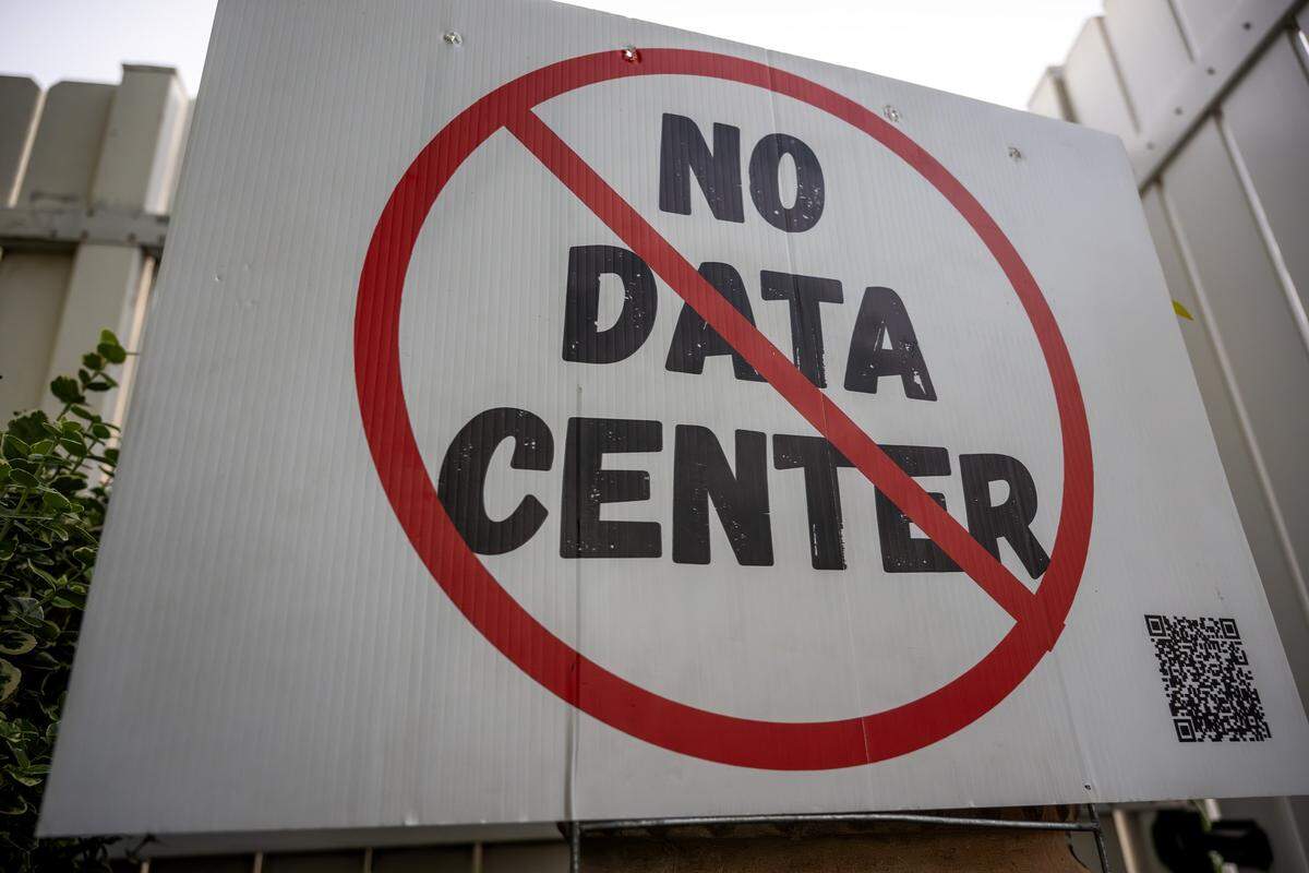 A "No Data Center" sign is displayed outside a town hall meeting at The Rhapsody on Tuesday, June 2, 2026, in Independence. Community members gathered to discuss opposition to the proposed Nebius data center project.