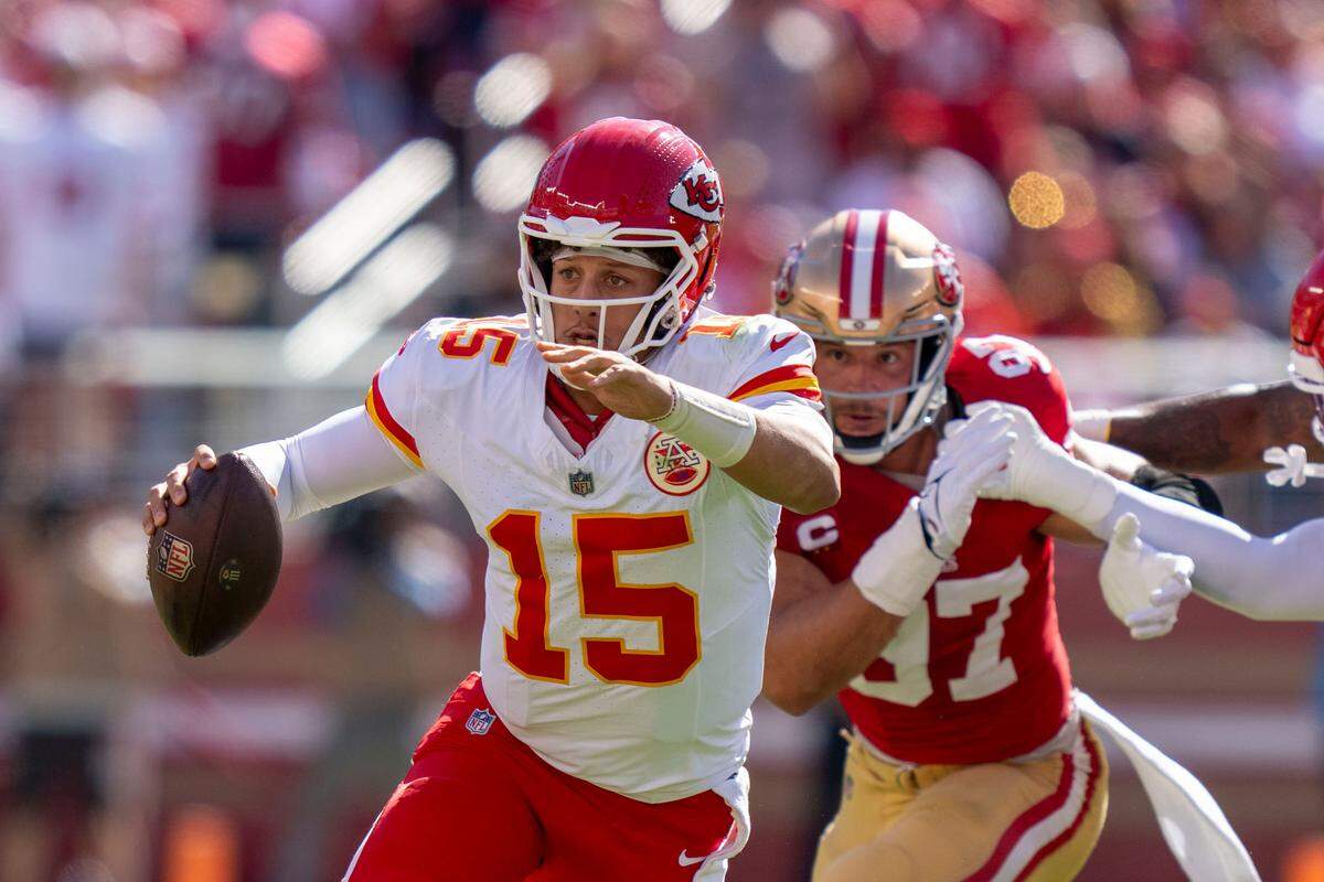Kansas City Chiefs quarterback Patrick Mahomes (15) runs the football against San Francisco 49ers defensive end Nick Bosa (97) during the first quarter at Levi’s Stadium.