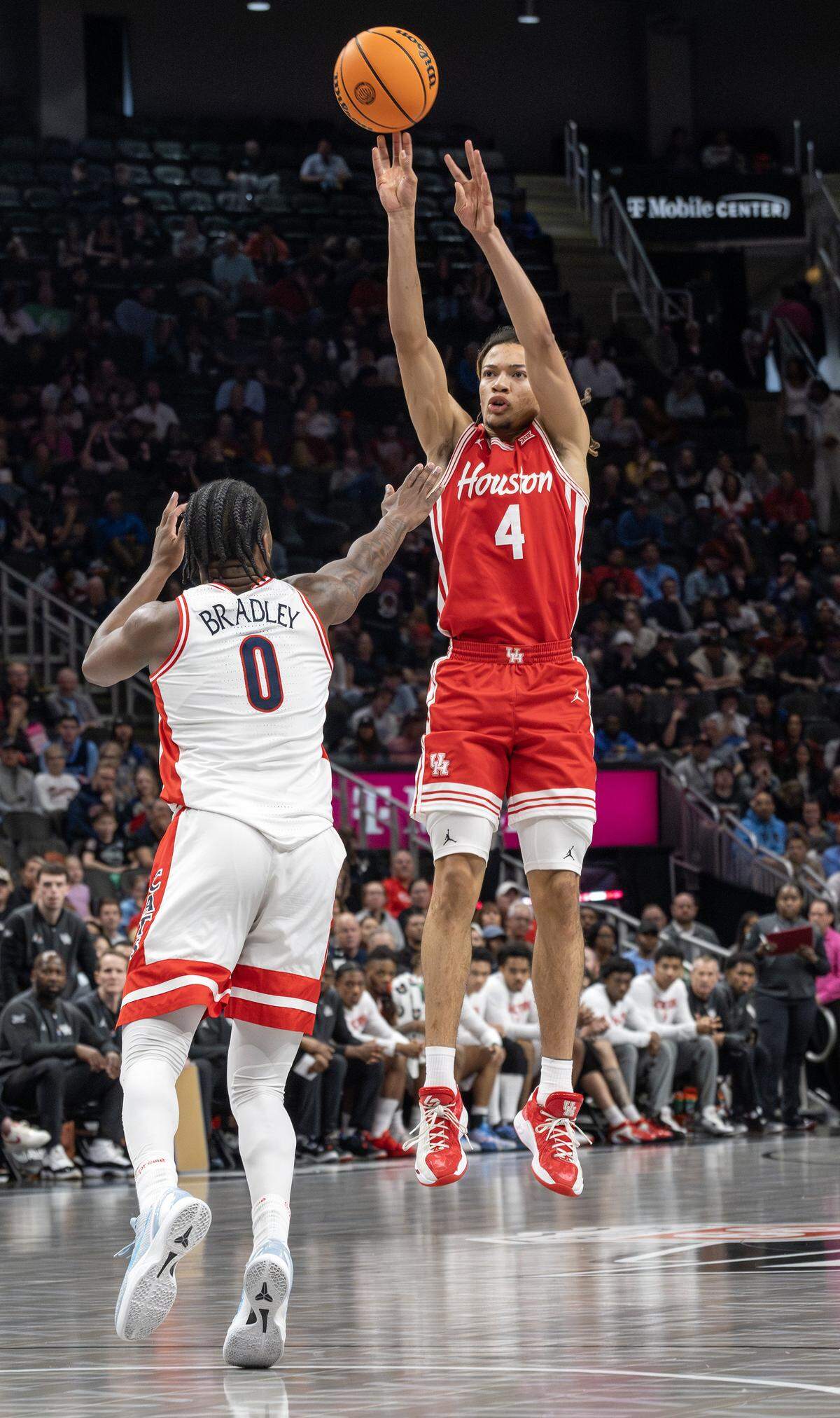 Houston Cougars guard Kingston Flemings (4) shoots a basket over Arizona Wildcats guard Jaden Bradley (0) during the second half of the Big 12 Men's Basketball Tournament Championship game at T-Mobile Center on Saturday, March 14, 2026, in Kansas City.