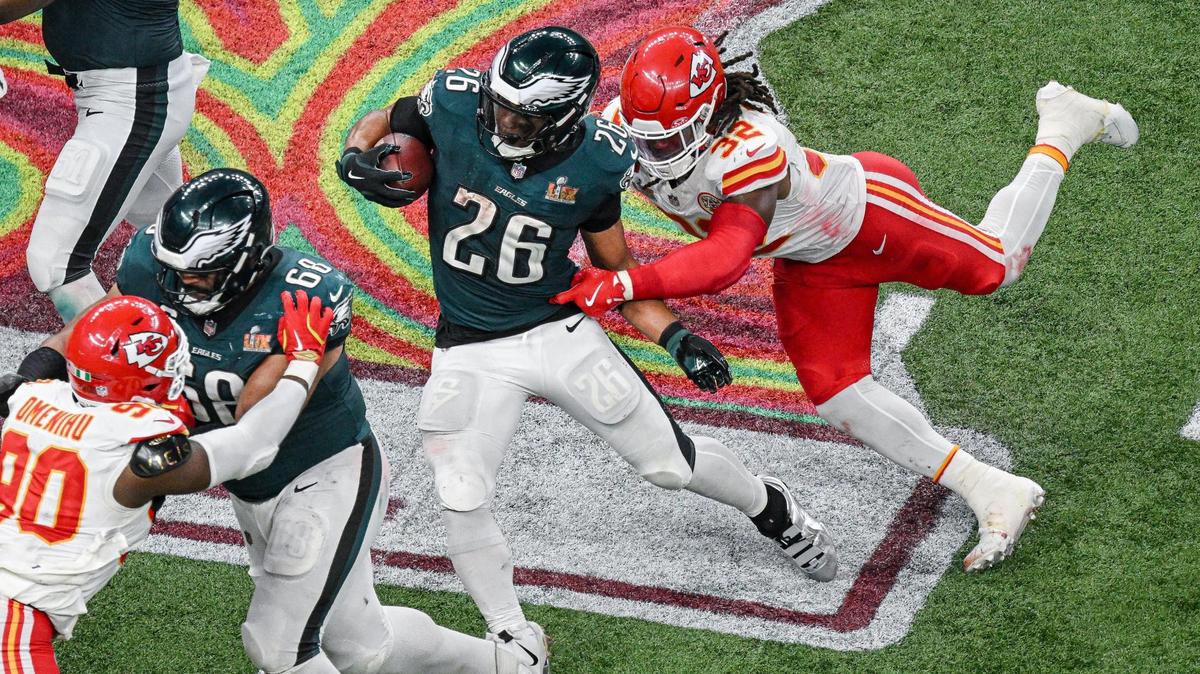 Kansas City Chiefs linebacker Nick Bolton (32) attempts to stop Philadelphia Eagles running back Saquon Barkley (26) on a run during Super Bowl LIX on Sunday, Feb. 9, 2025, in New Orleans.