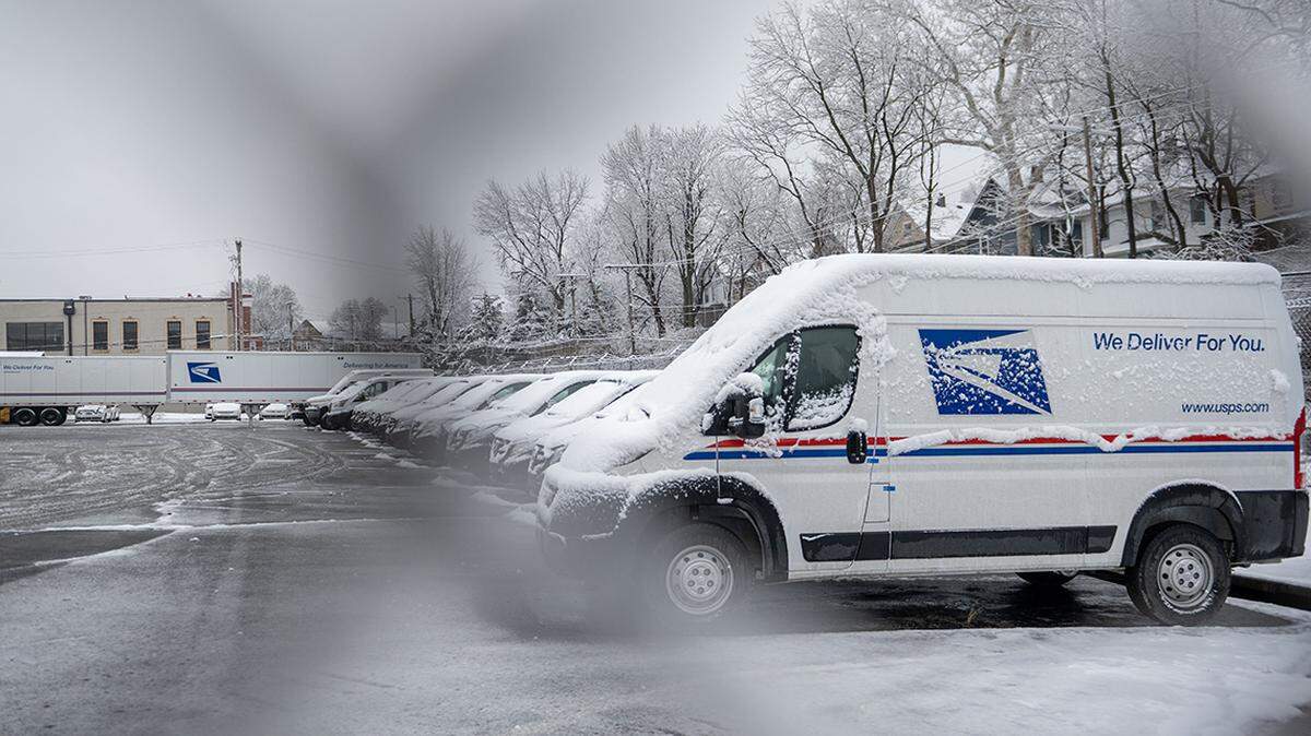 U.S. Postal Service vehicles remain parked at a facility after a snowfall on Wednesday, Jan. 25, 2023, in Kansas City. 