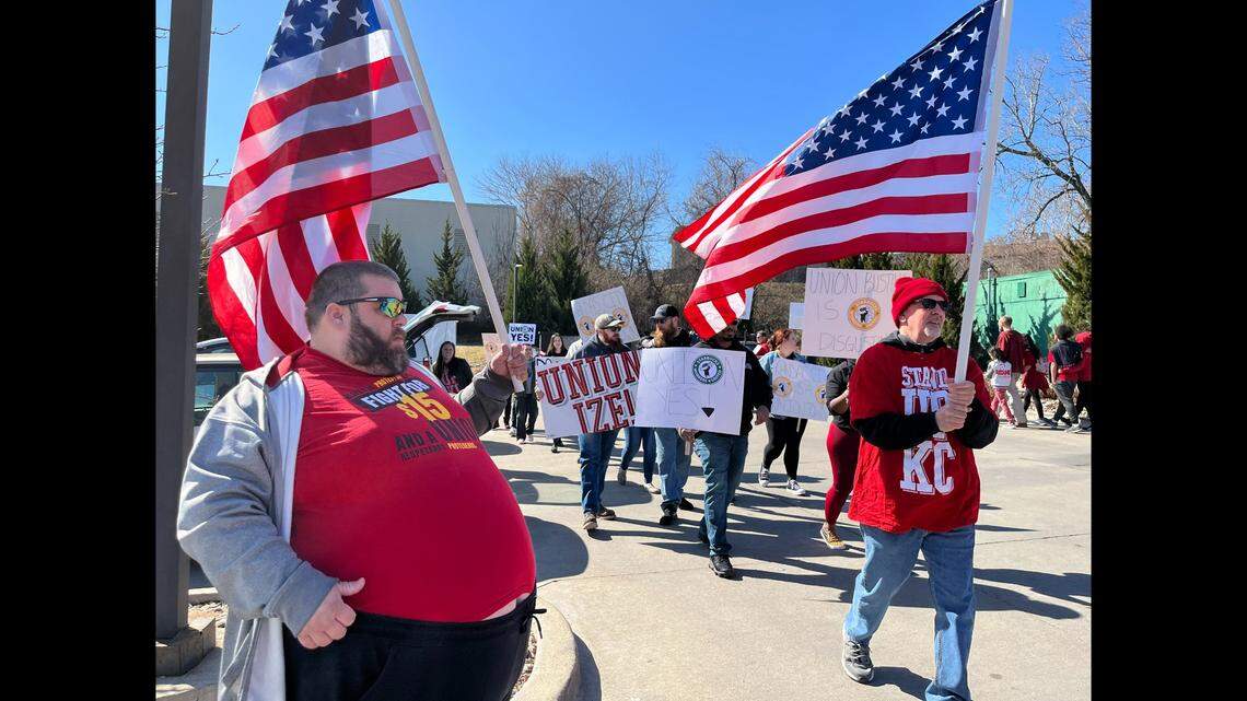 Aaron Bassett, who works at a Wendy’s restaurant in the area, marches alongside Starbucks employees and members of Stand Up KC to demand fair treatment on Saturday in Overland Park.