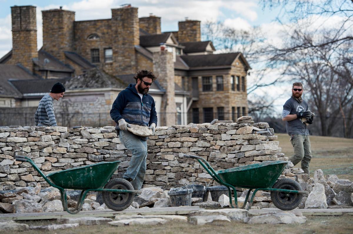 Matthew Hayden (center) and others moved pieces of limestone while building the “Walking Wall” by artist Andy Goldsworthy on grounds just east of The Nelson-Atkins Museum of Art. The first phase of the wall went up well ahead of schedule at a pace of about 12 yards a day.