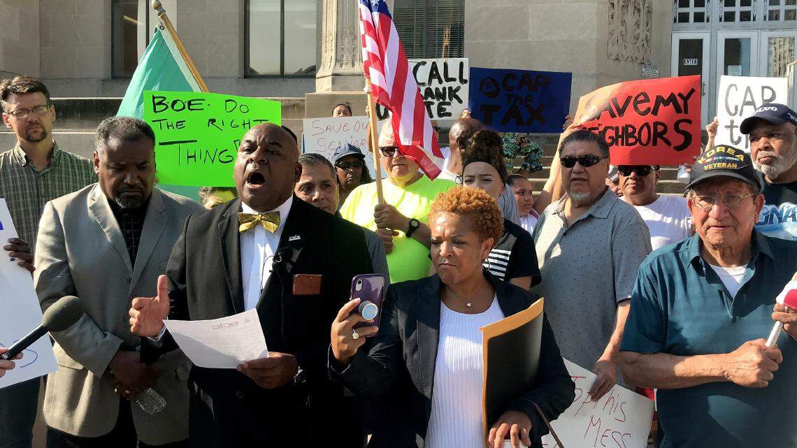 Protesters angered by increases in property assessments gathered on the steps of the Jackson County Courthouse with the Rev. Vernon Howard, president of the SCLC-GKC, on July 29, 2019.