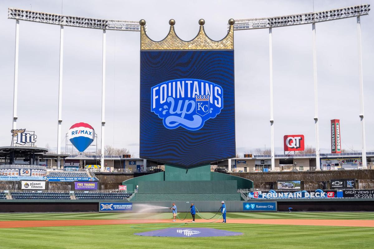 Grounds crew workers water the infield at Kauffman Stadium on Tuesday, March 25, 2025. Crews worked throughout the day to prepare for Opening Day for the Kansas City Royals.