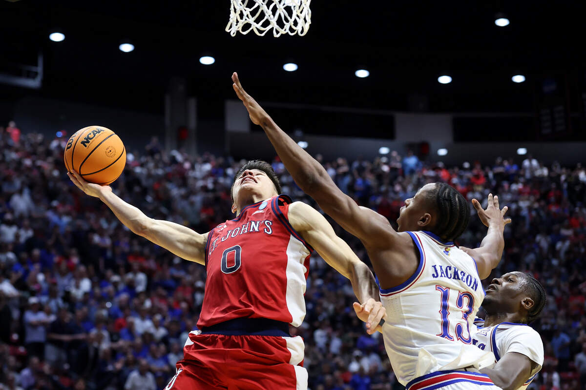 Dylan Darling #0 of the St. John's Red Storm scores the game-winner over Elmarko Jackson #13 of the Kansas Jayhawks in the closing seconds at Viejas Arena on March 22, 2026.