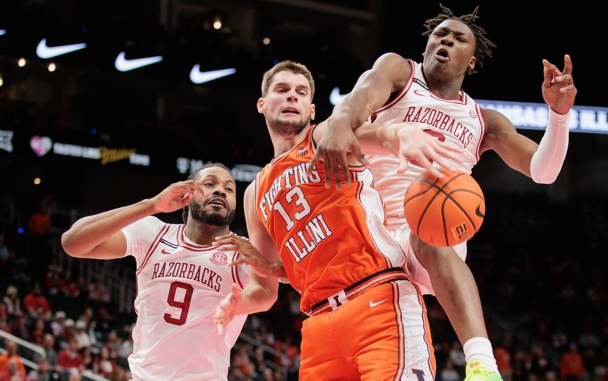 Arkansas Razorbacks forward Adou Thiero (No. 3) battles Illinois Fighting Illini center Tomislav Ivisic (No. 13) for a rebound during a men’s college basketball game at T-Mobile Center in Kansas City on Thanksgiving Day, Thursday, Nov. 28, 2024. 