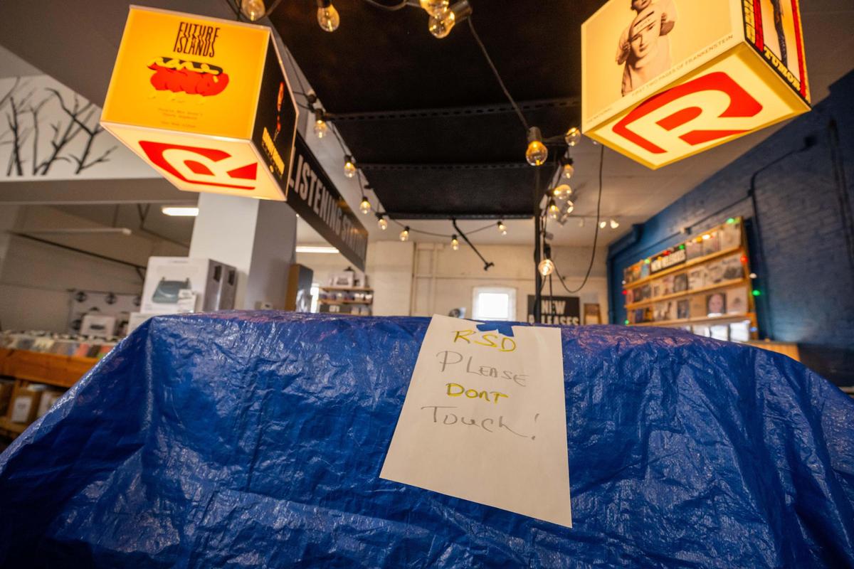 A blue tarp covers exclusive Record Store Day items at Mills Record Company on Friday, April 11, 2025, the day before Record Store Day.
