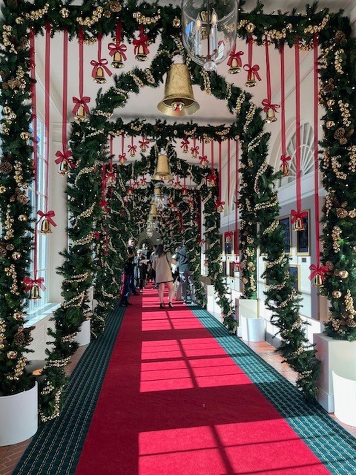 The East Colonnade is decorated in a bell theme, with brass-colored bells suspended from the ceiling and sleigh bells lining the archways.