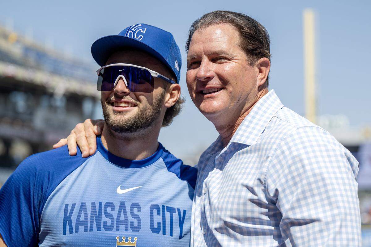 Kansas City Royals catcher Carter Jensen (22) and former first baseman Mike Sweeney pose for a photo during batting practice before the home opener against the Minnesota Twins at Kauffman Stadium on Monday, March 30, 2026, in Kansas City.