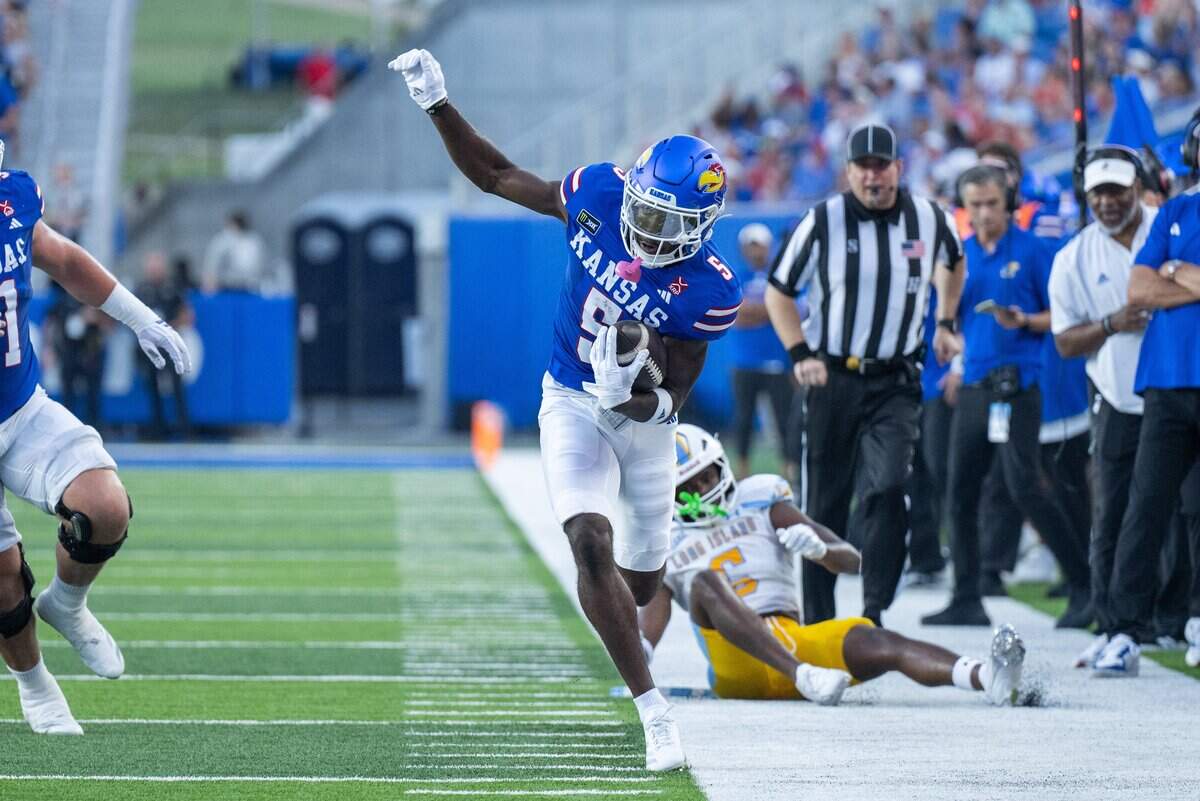 Kansas Jayhawks wide receiver Nik McMillan (5) tight ropes the sideline after a catch in the first half of the Jayhawks game vs. Long Island University Sharks at David Booth Memorial Stadium on Friday, September 4, 2026, in Lawrence.