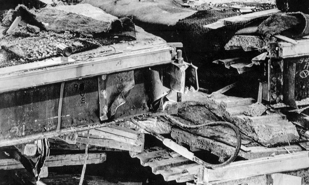 Pictured is a section of the highest of two sky walks that collapsed July 17, 1981, at the Hyatt Regency Hotel, killing 114 persons. The mangled box beam near the center of the photo is where the structural failure occurred that allowed the upper skywalk to detach from its support rod and drop down along with the second floor skywalk that was suspended below it onto the floor below.